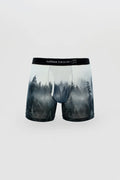 Misty forest-themed men’s boxer briefs in soft translucent fabric with black elastic waistband featuring curious beaver logo