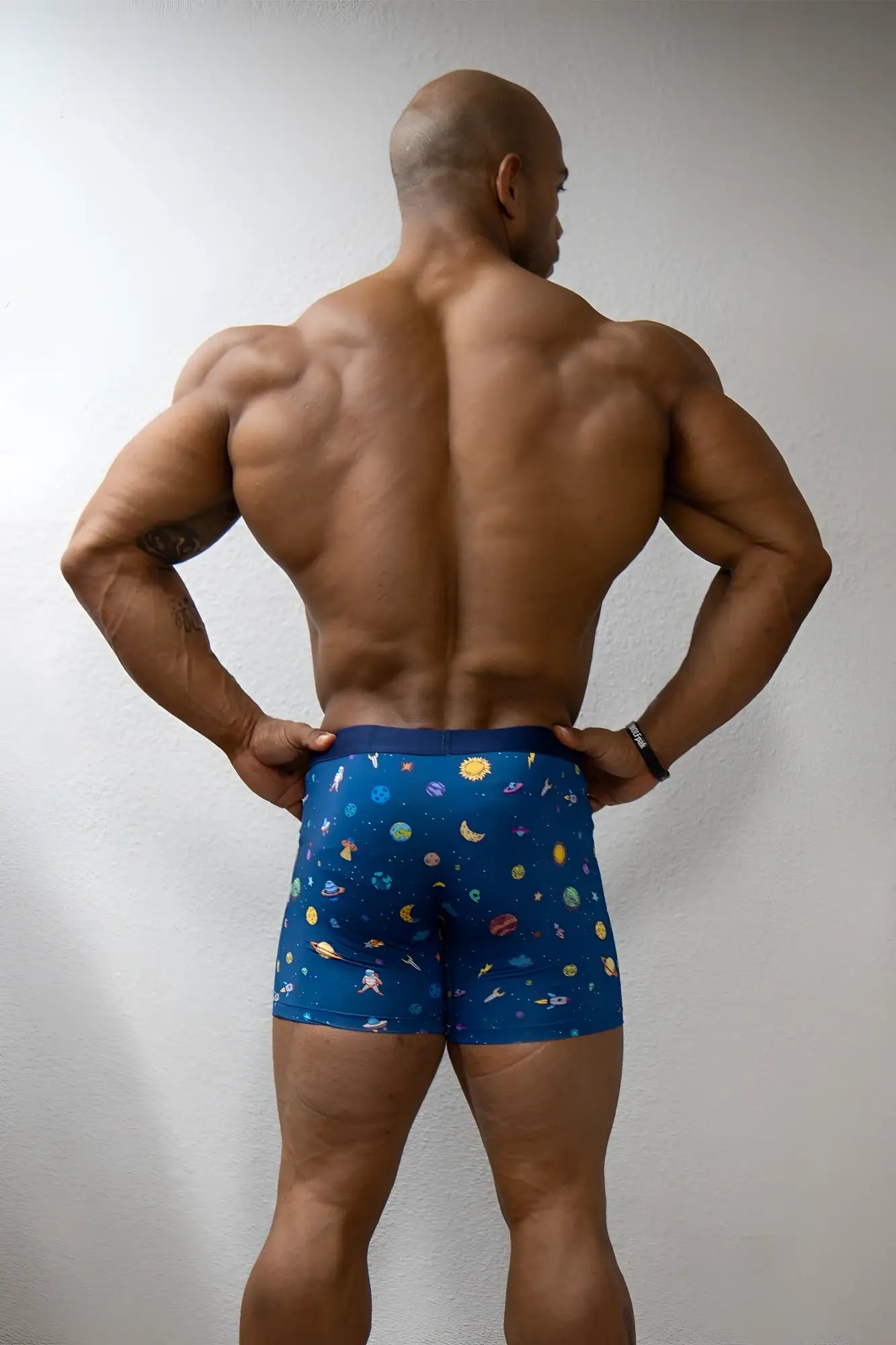 Men’s blue boxer briefs with a space-themed pattern of planets moons and stars galaxy design