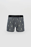 Men’s gray boxer briefs with cartoon penguin pattern and black curious beaver branded elastic waistband