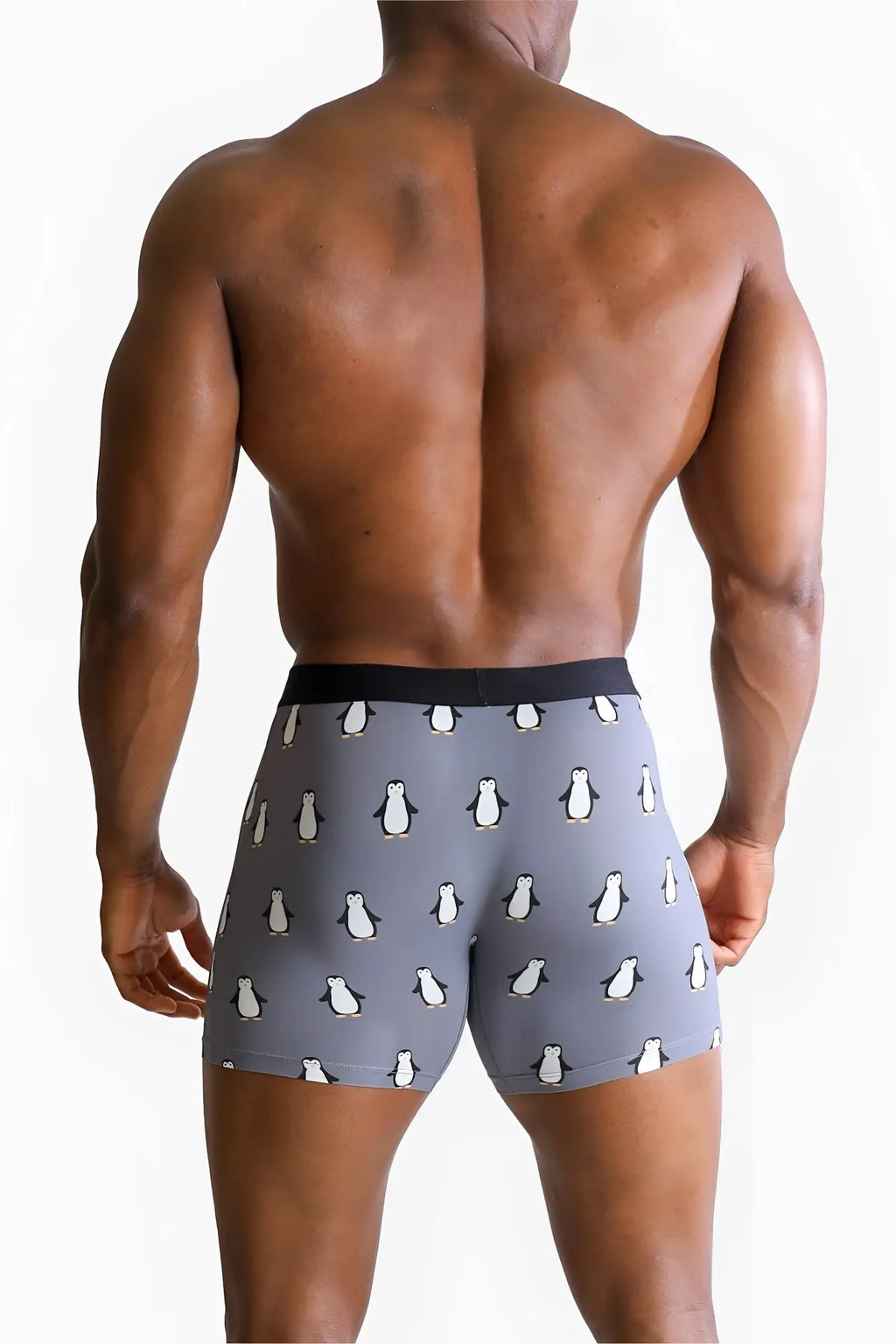 Men’s gray boxer briefs with a penguin pattern and solid black waistband for comfortable everyday wear