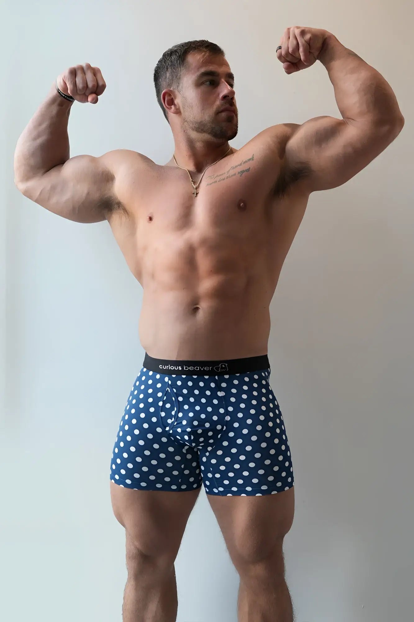 Men’s boxer briefs in blue and white polka dots with a black waistband featuring curious beaver logo