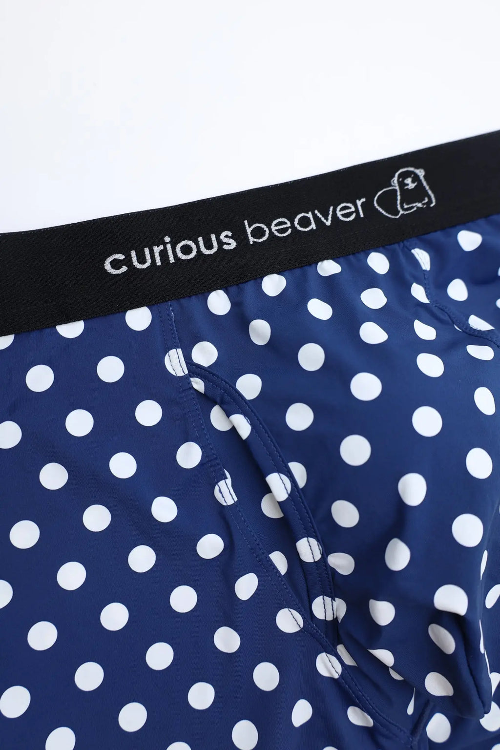 Men’s navy blue polka dot boxer briefs with white dots and black waistband featuring curious beaver logo