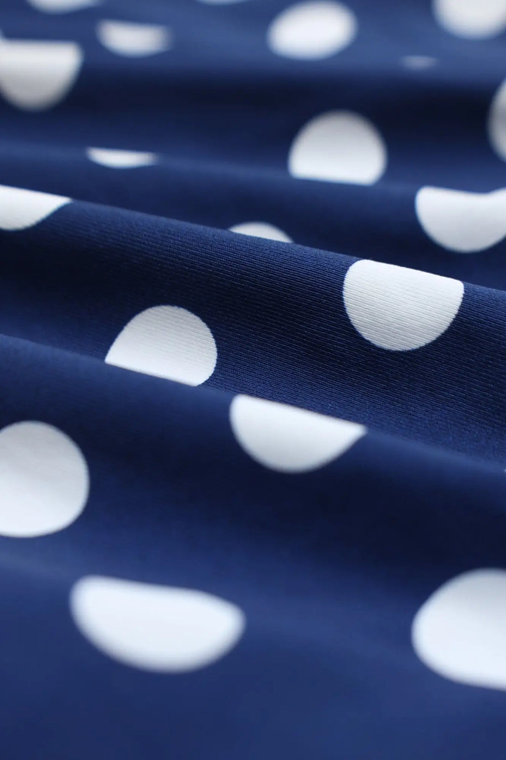 Navy blue men’s boxer briefs with white half-circle polka dots made from soft breathable fabric