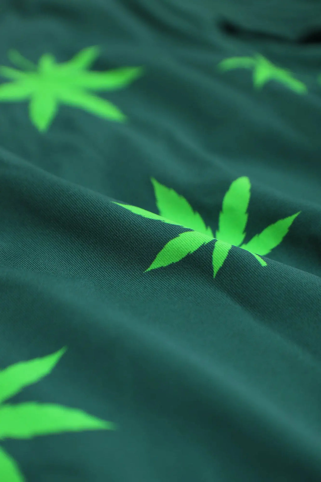 Men’s boxer briefs in dark green fabric with a bright neon green cannabis leaf pattern for comfortable wear