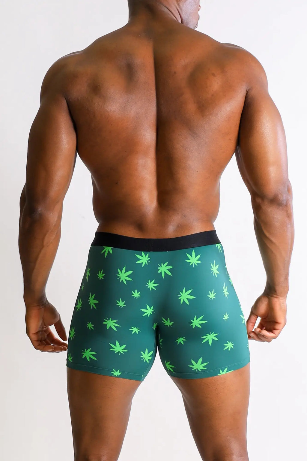 Men’s boxer briefs with green cannabis leaf pattern and black waistband made of soft breathable fabric for everyday wear