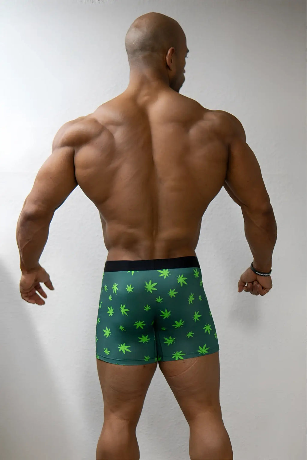 Men’s green boxer briefs with neon green cannabis leaf pattern and black waistband designed for comfortable wear
