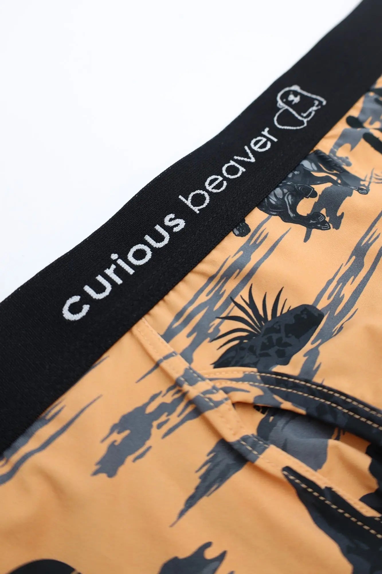 Men’s boxer briefs wild west in orange with black and gray abstract animal print and curious beaver branded waistband