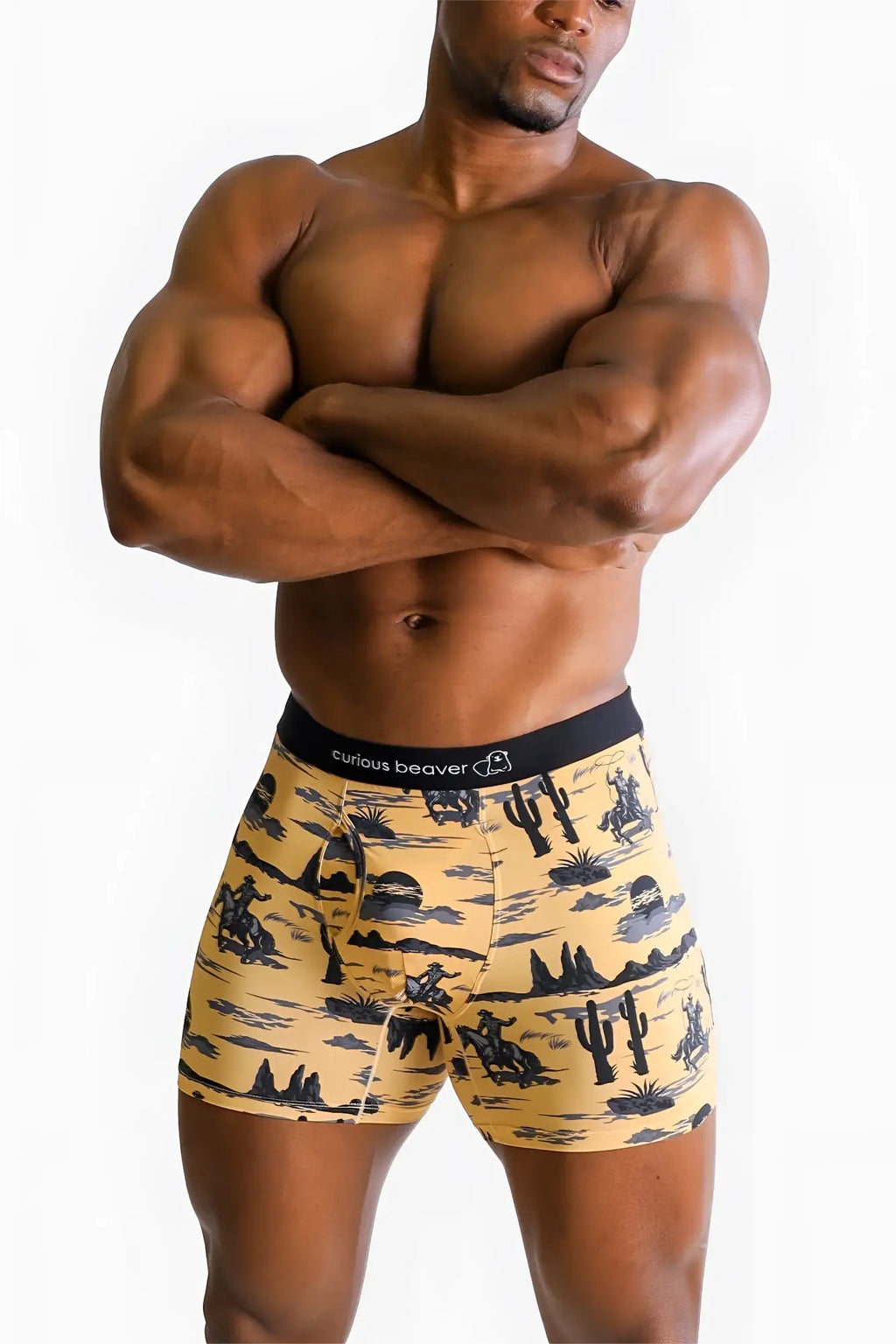 Men’s yellow boxer briefs with black desert-themed cacti and cowboys pattern branded curious beaver Wild West design