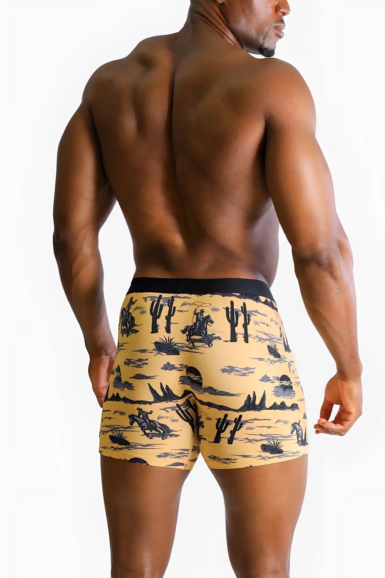 Yellow men’s boxer briefs with black and gray wild west pattern featuring cacti riders and desert landscapes