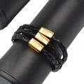 Men’s black braided leather bracelet with adjustable silver clasp and three gold-toned foco pr força charms