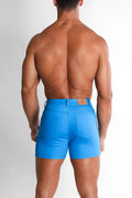 Men’s color pop 3.5 inch cyan blue denim shorts showing back with brown leather brand patch on waistband