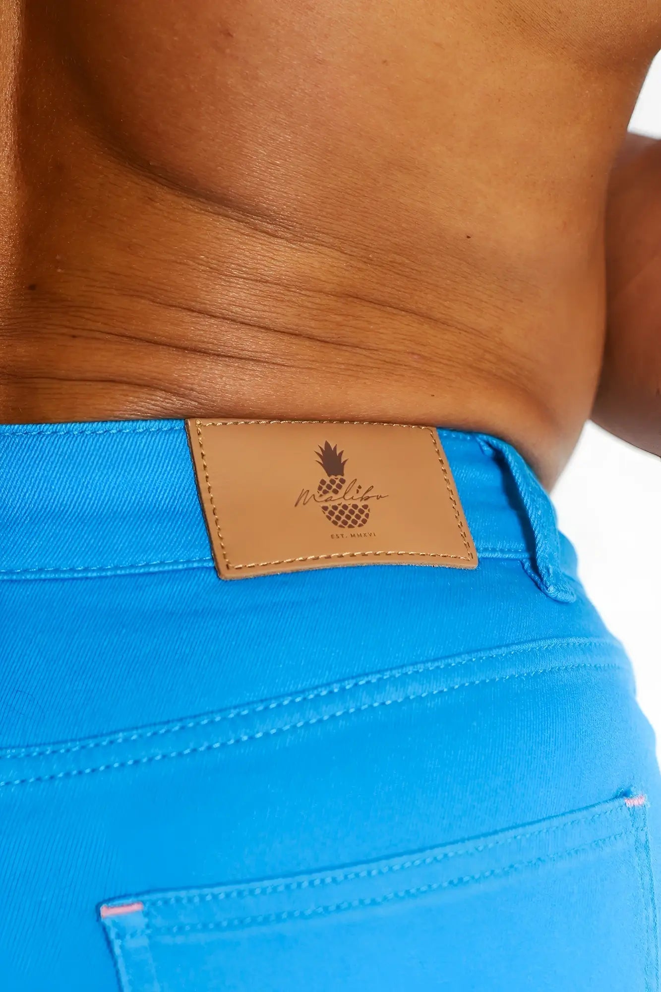 Men’s cyan blue color pop 3.5 inch denim shorts featuring bright blue denim and a tan leather patch with mellow pineapple logo