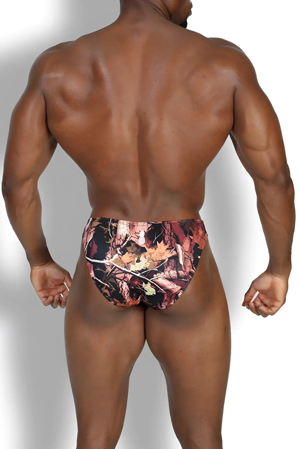Men’s slimmer bulge briefs in bayou swamp camouflage with earthy browns oranges blacks and detailed leaf and branch designs