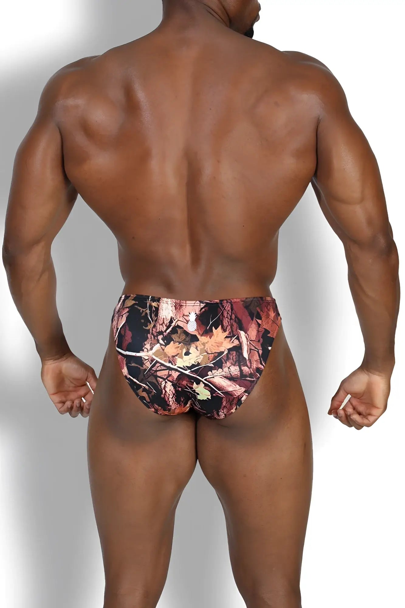 Men’s slimmer bulge briefs in bayou swamp camouflage with earthy browns oranges blacks and detailed leaf and branch designs