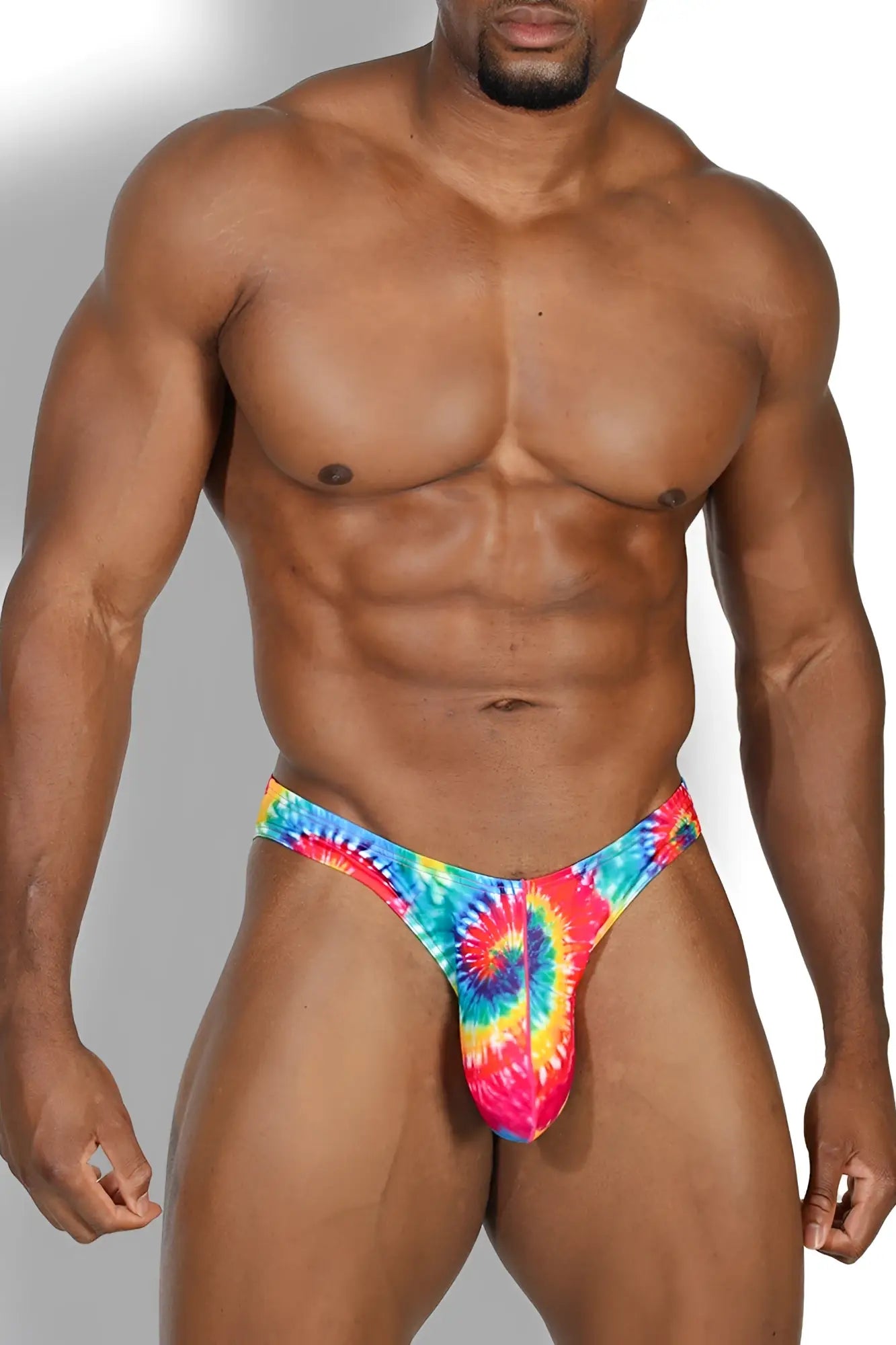 Men’s slimmer bulge briefs jockstrap with vibrant blue red yellow pink spiral tie dye pattern for bold style