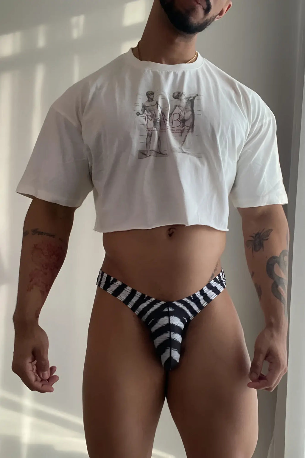 Men’s slimmer bulge briefs in black and white zebra print with a bold geometric thong design