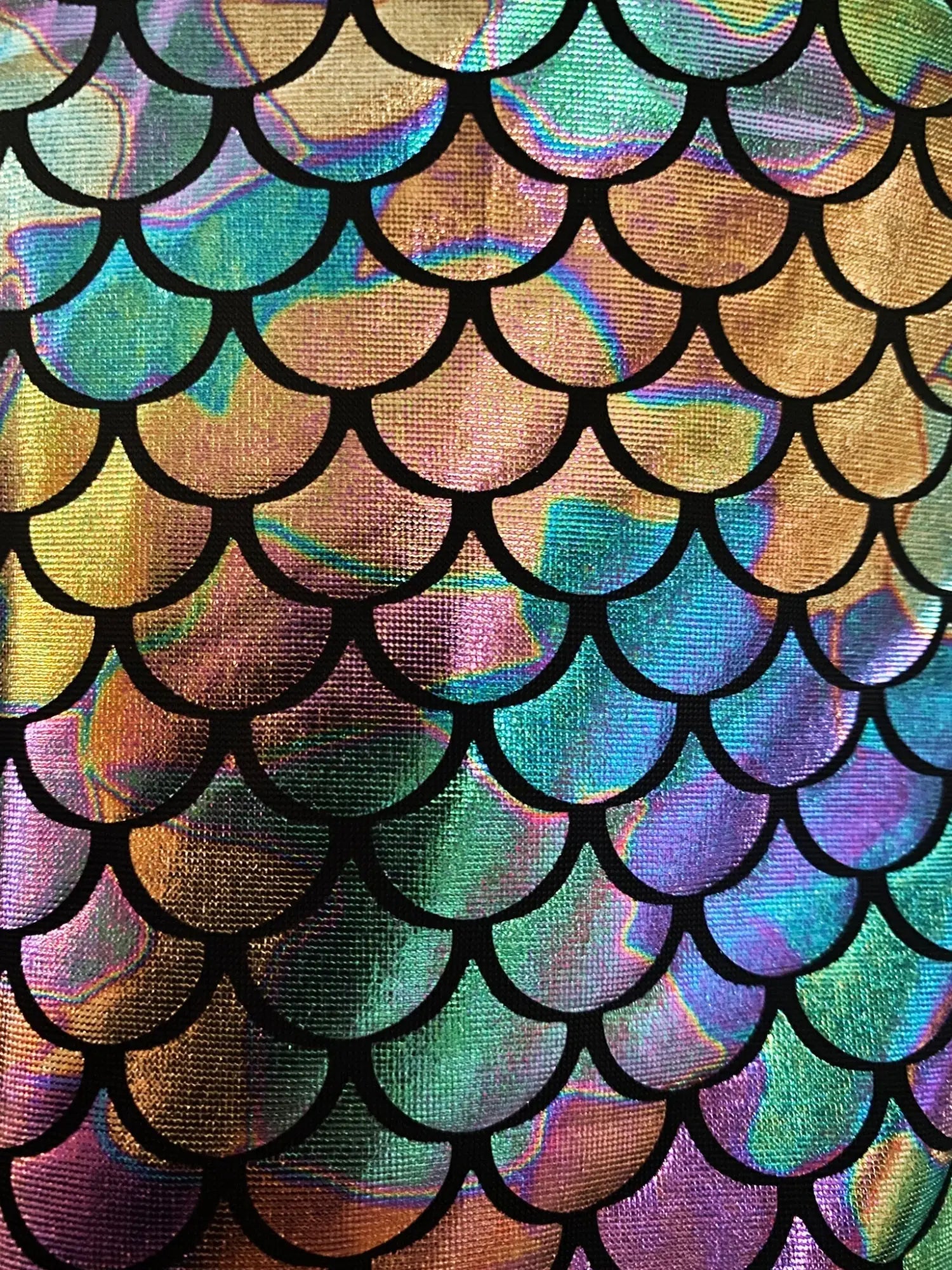 Iridescent mermaid-scale patterned fabric with black outlines on merman hooded crop tank front view
