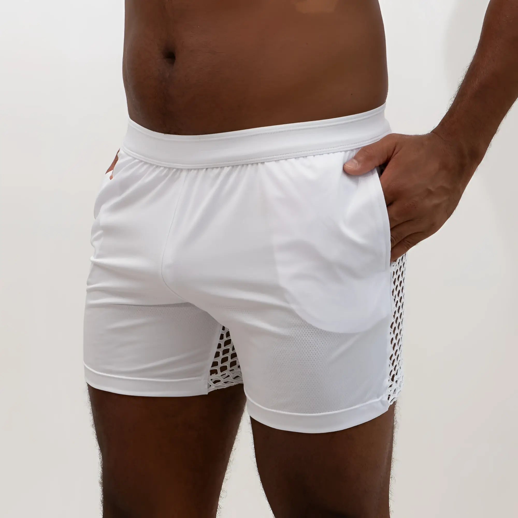 White athletic shorts with mesh side panel and solid fabric main body designed for performance use
