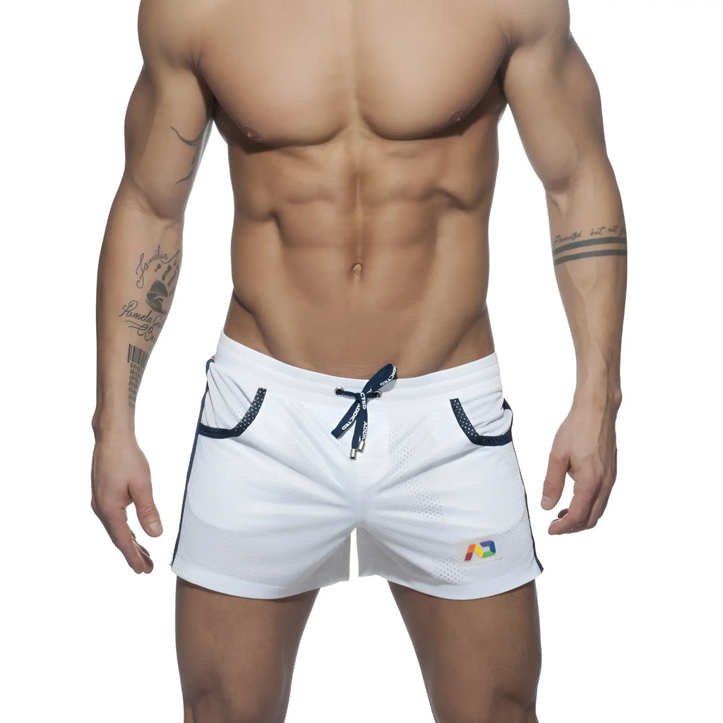 White mesh athletic shorts with navy blue drawstring and trim featuring a colorful rainbow logo on the lower right leg