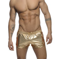 Shiny gold metallic swim trunks with a drawstring waistband and side pockets for stylish beachwear