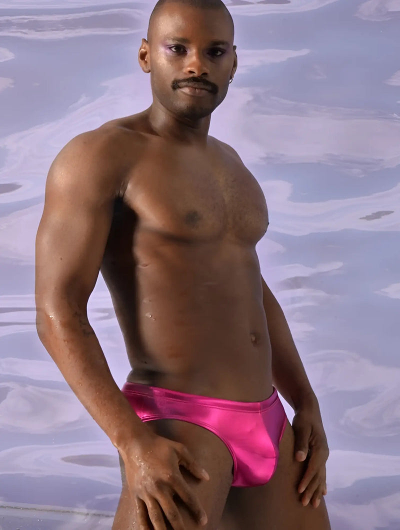 Bright pink shiny satin metallic swim brief designed as swim trunks for vibrant beachwear