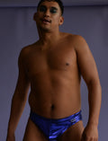 Shiny royal blue metallic swim brief with a small white logo on the left hip for stylish swimwear use