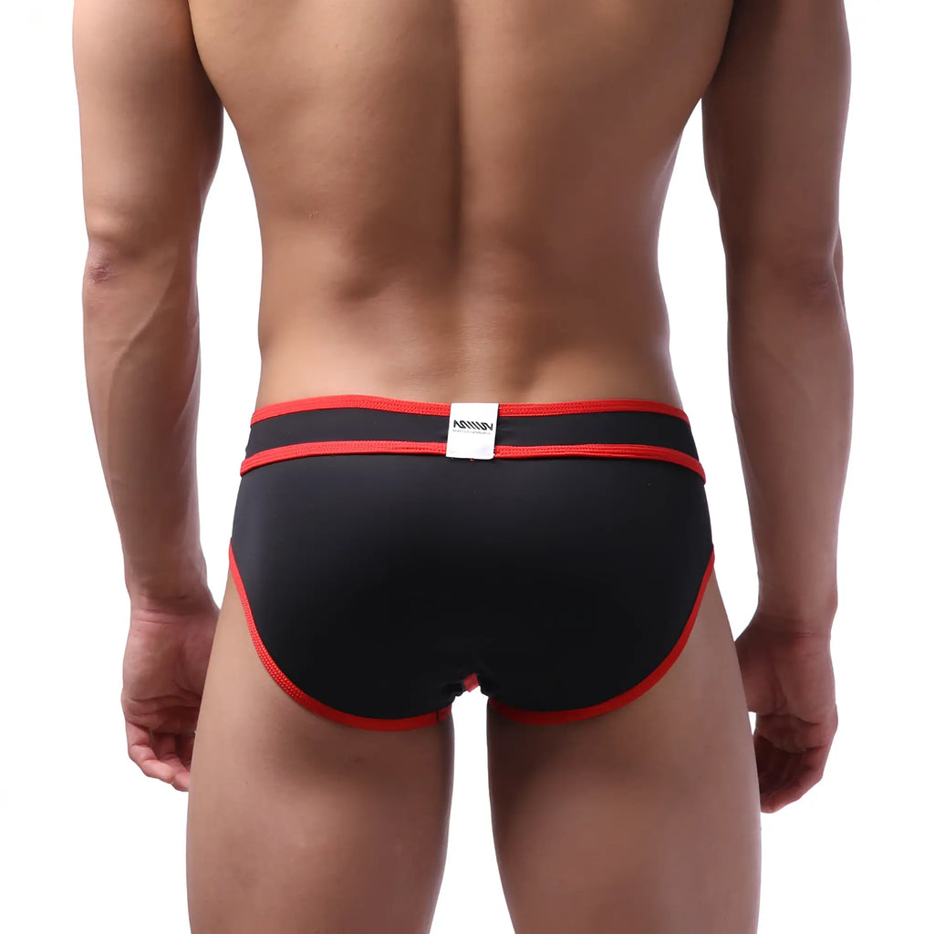 Black metroMalewear bold swim brief with red trim and white waistband label designed for swimming and beachwear