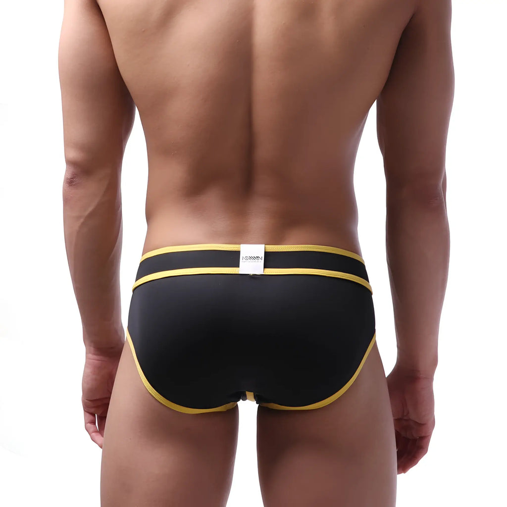 Black metro malewear swim briefs with bold yellow trim and a white brand tag at the waistband