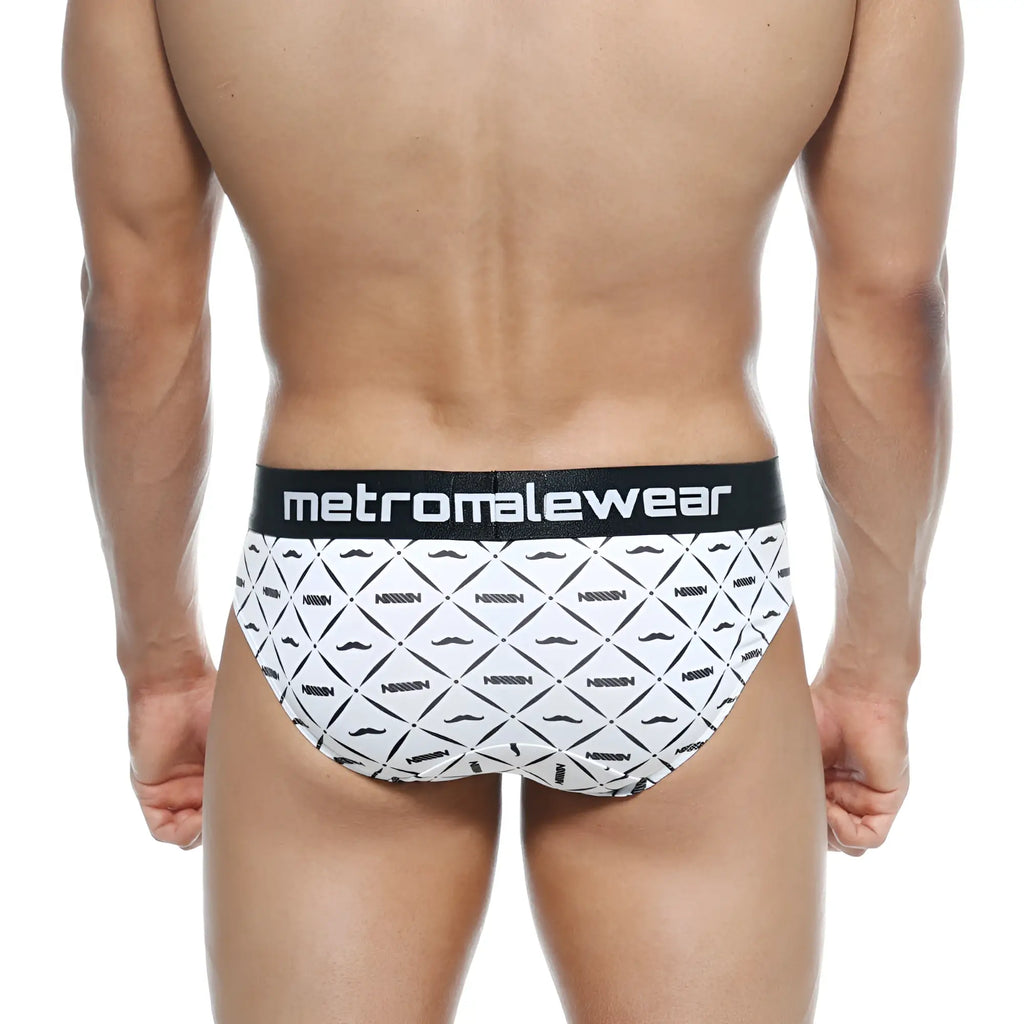 White briefs with black geometric mustache pattern and norris text, black waistband with metromalewear logo, metro malewear brief caballero 5006-03