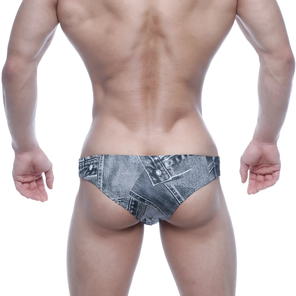 Denim-patterned swim trunks in faded blue-gray wash with stitched seams and button details