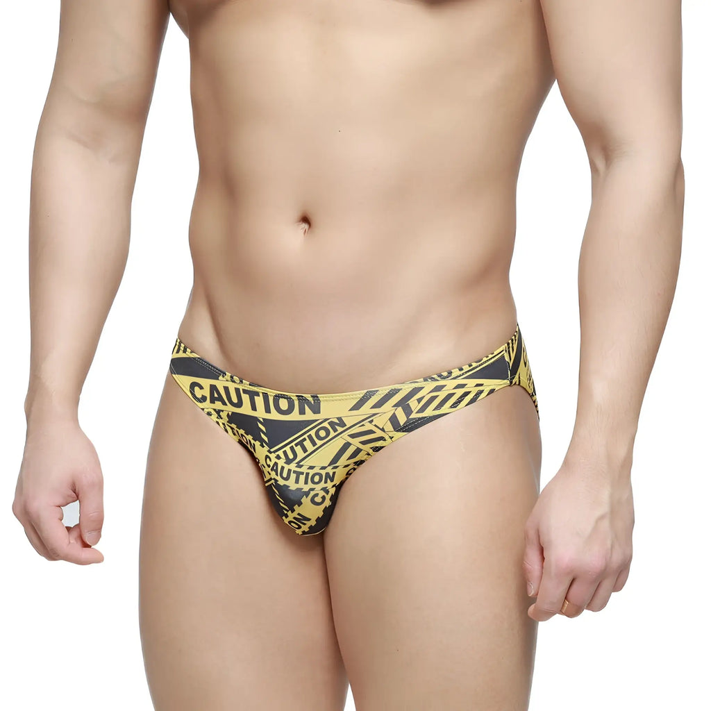 Men’s lowrise bikini briefs by metromalewear in yellow and black caution tape pattern with comfortable fabric