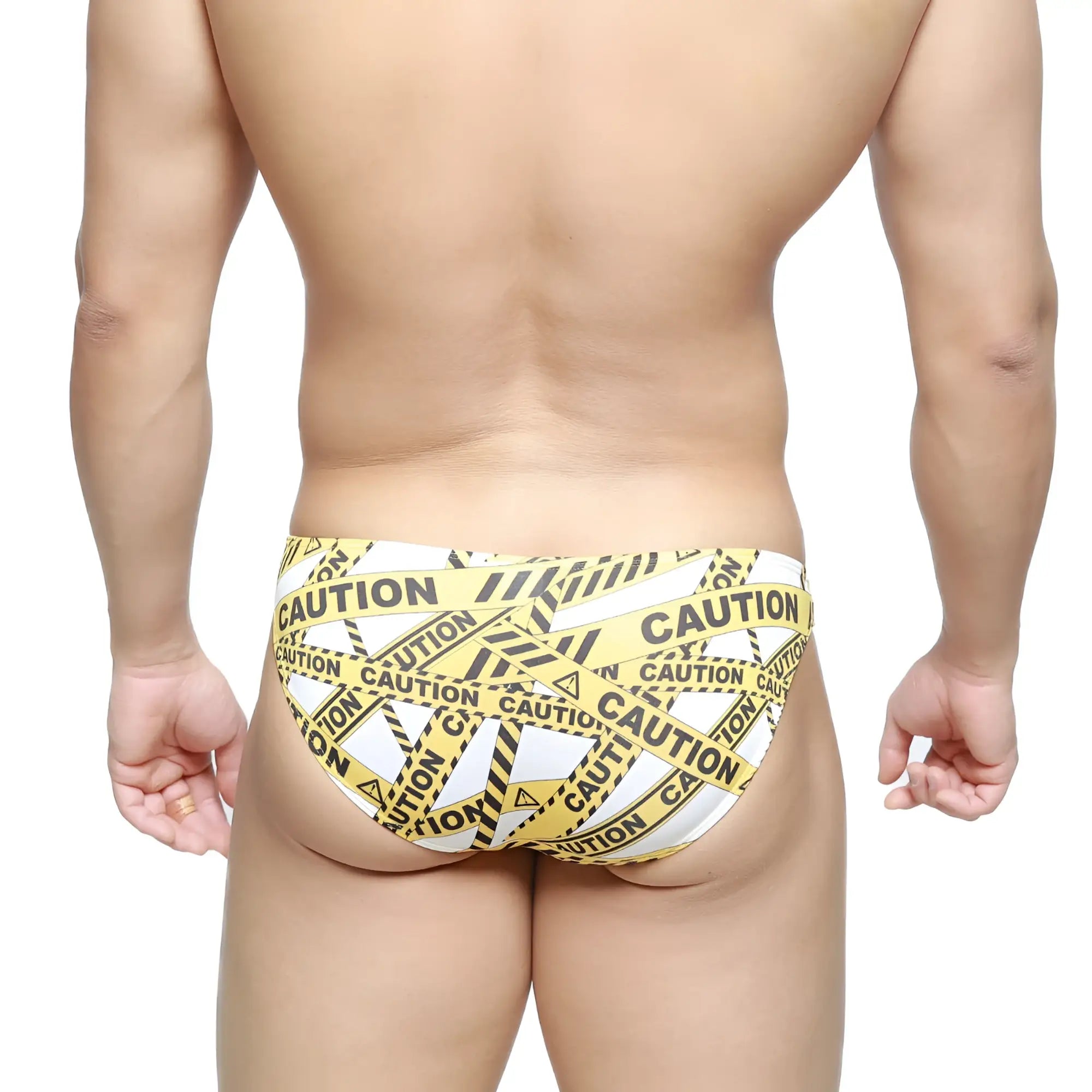 Yellow and black caution tape patterned swim trunks by MetroMaleWear lowrise bikini style in white background