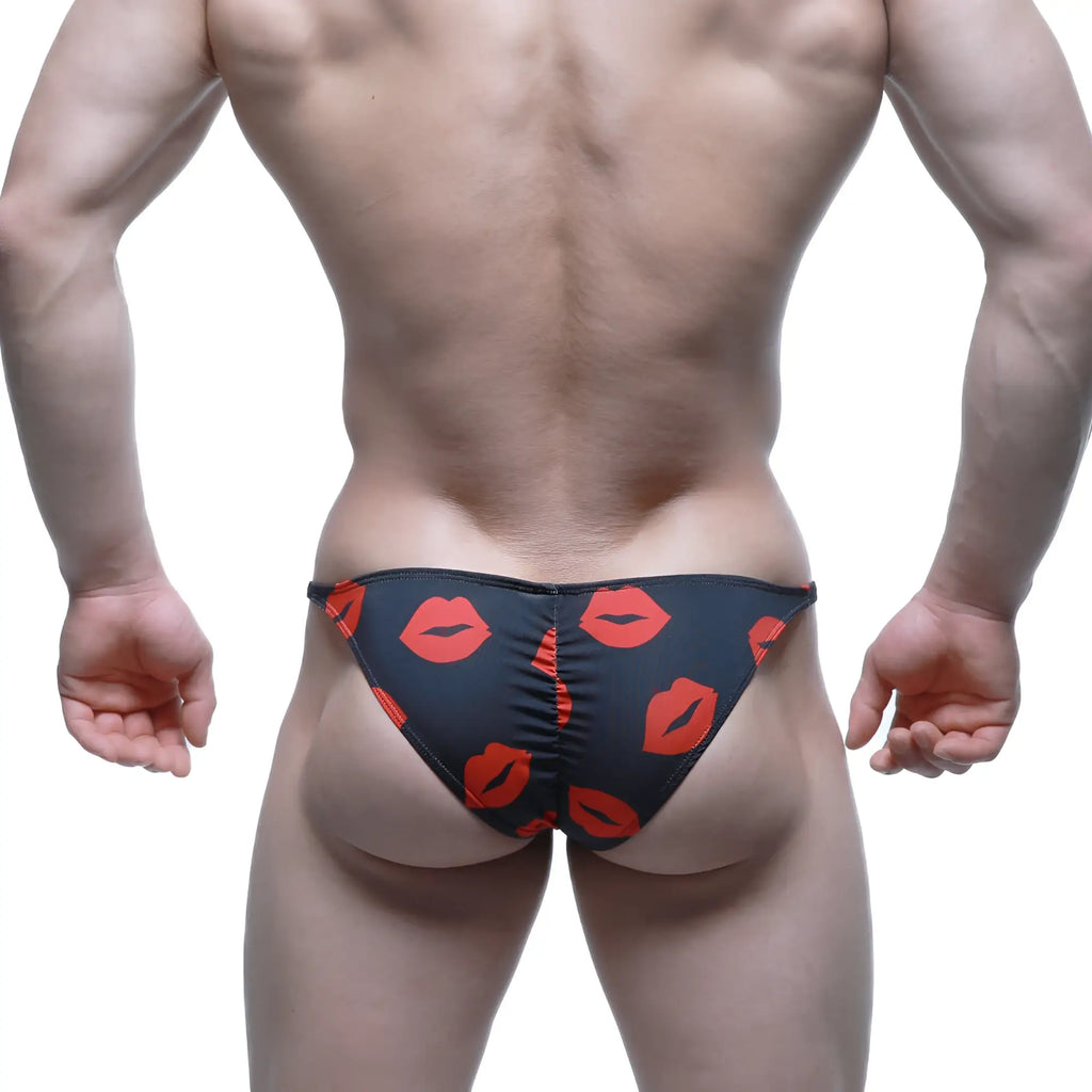 Black swim trunks with bold red lipstick prints from MetroMaleWear fantasy bikini kiss 6116-62 product line