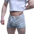 MetroMaleWear fit gray heathered sweatshorts with white drawstring and circular logo patch on lower left leg