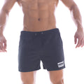 Black athletic swim shorts with drawstring waistband and white rectangular logo patch on lower right leg by metromalewear