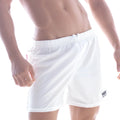 White athletic swim shorts with elastic waistband and logo patch on lower right leg from metromalewear