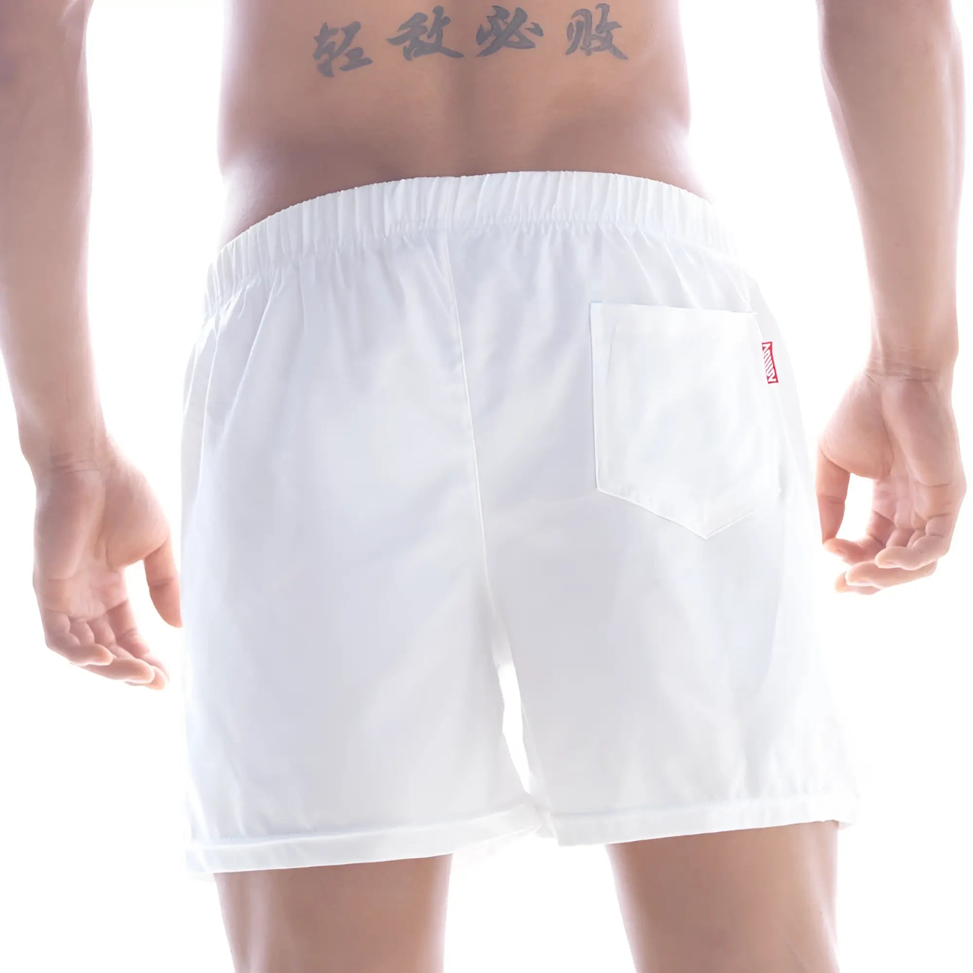 Back view of metro male wear flexible swim trunk white with elastic waistband and red logo on single back pocket