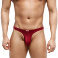 A sleek deep red mens thong made of smooth stretchy fabric with subtle sheen and white brand tag at waistband