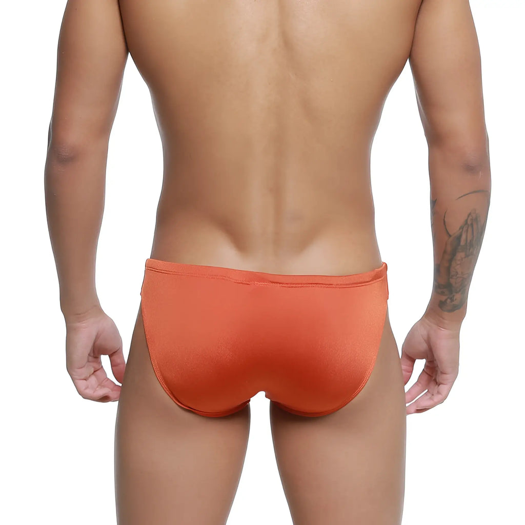 Orange MetroMaleWear Hunter swim brief in ochre features smooth, form-fitting fabric with a snug waistband