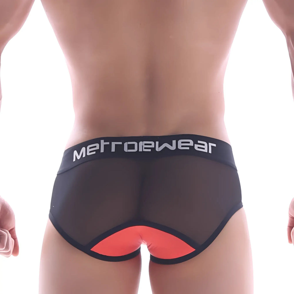 Back view of metro malewear joy mesh brief coral featuring black mesh fabric and vibrant orange triangular accent