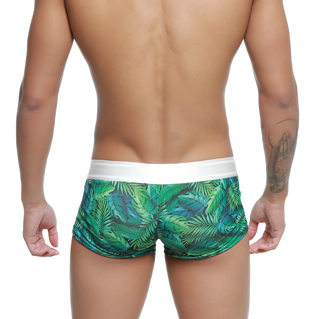 Green tropical leaf patterned swim trunks with white elastic waistband from metromalewear jungle trunk 2026-08