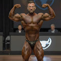 A muscular man wearing leopard-print metroMalewear luxury swim bikini 4937-50 showcasing the front side