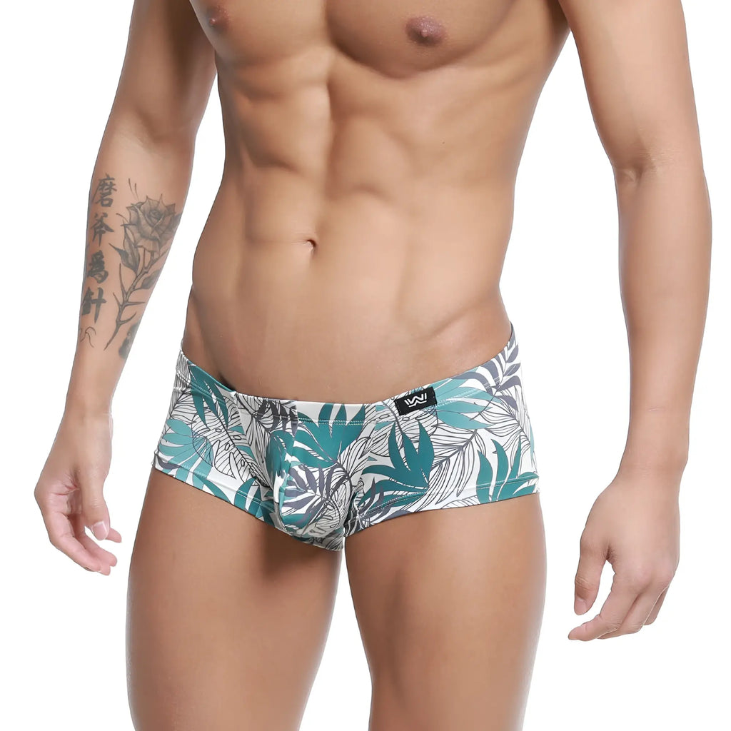 White briefs by MetroMaleWear Meadow Trunk 2125-56 with vibrant teal and gray tropical leaf pattern and black logo waistband