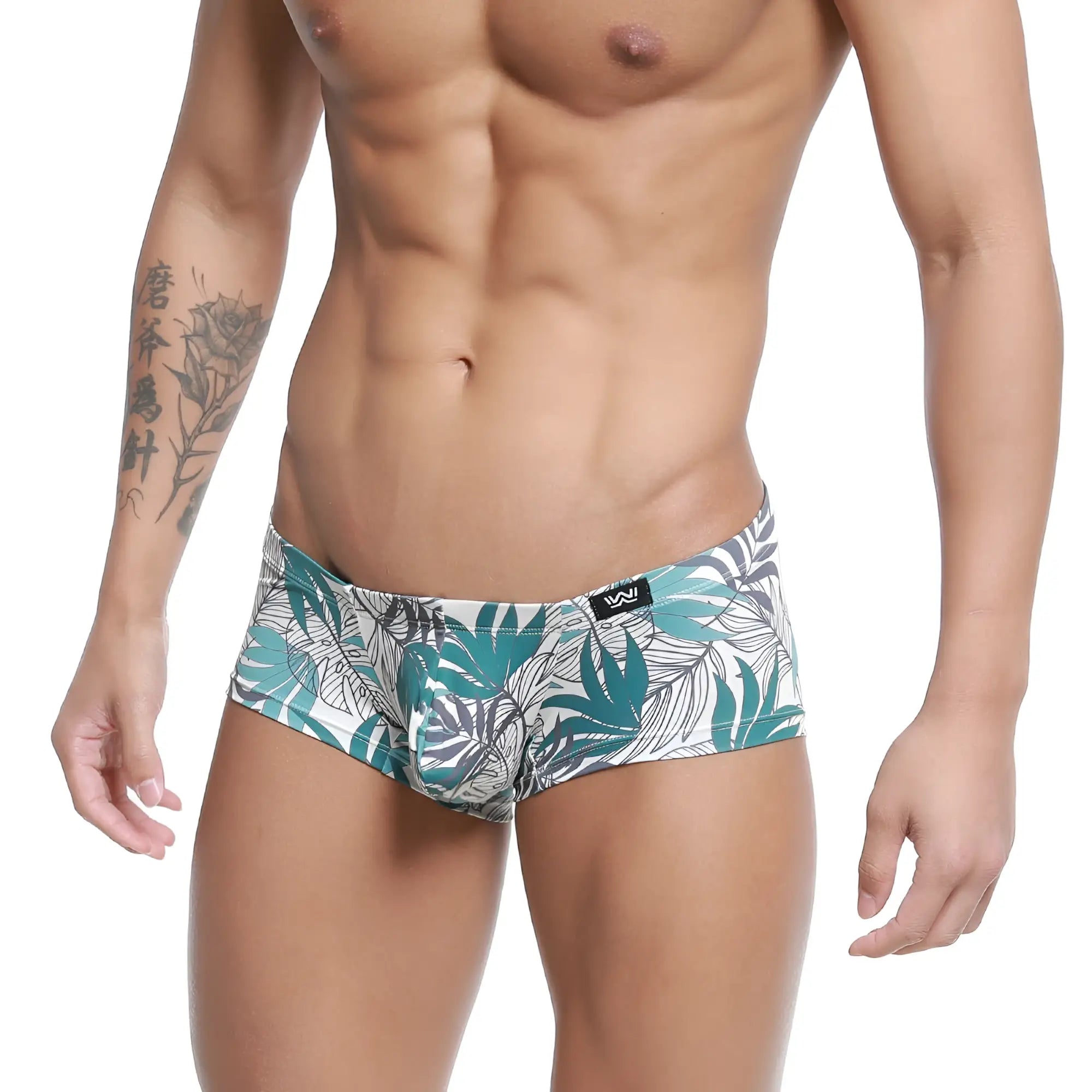 White briefs by MetroMaleWear Meadow Trunk 2125-56 with vibrant teal and gray tropical leaf pattern and black logo waistband