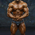 A muscular male bodybuilder wearing metroMalewear basic competition suit with blue and white stripes