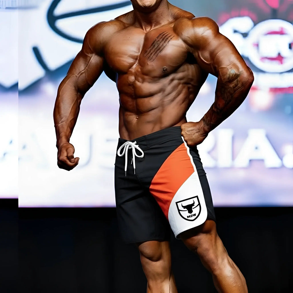 MetroMaleWear MetroMuscleWear IFBB Pro mens physique board short in black orange and white with white drawstring and bull logo
