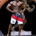 MetroMaleWear MetroMuscleWear IFBB Pro mens physique board short with blue red white stripes and black bull logo on left leg