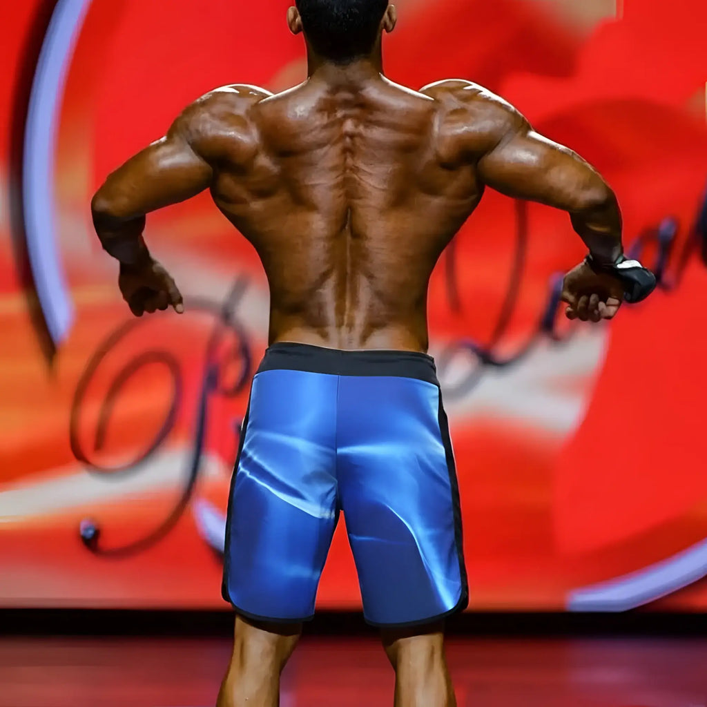 Blue MetroMaleWear MetroMuscleWear IFBB Pro mens physique board shorts with glossy finish and black trim sides and waistband