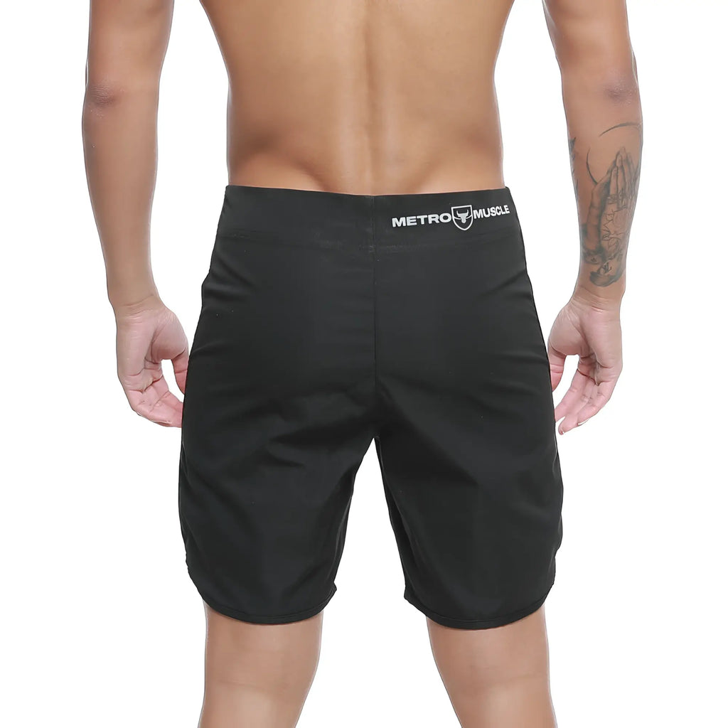 Black metro muscle men’s shorts with athletic cut and white branded waistband from MetroMaleWear Intenso Physique board short