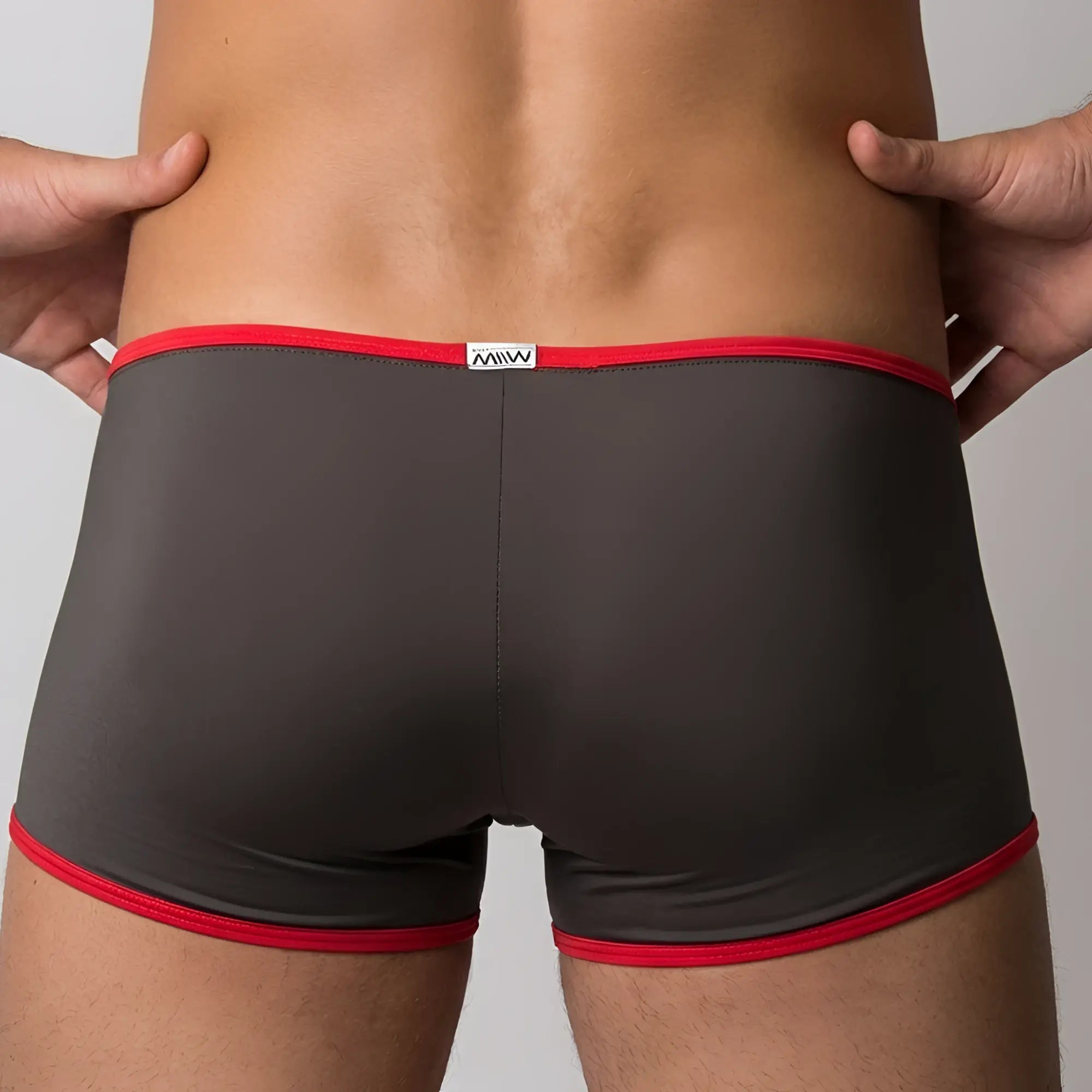 Dark gray MetroMaleWear Minimo boxer briefs with bold red trim and a small white mww brand label